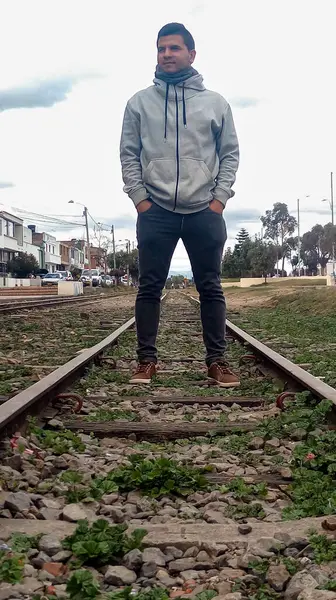 Happy Latin man on train rail in Zipaquira - Cundinamarca - Colombia