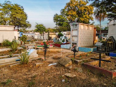 Graves in the Central Cemetery of Neiva on a hot afternoon clipart