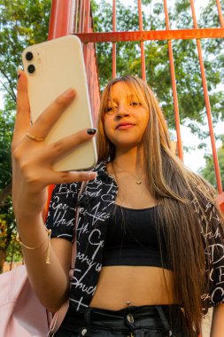 Neiva 'da sağ elinde akıllı telefonla genç bir Latin kadın Huila - Kolombiya