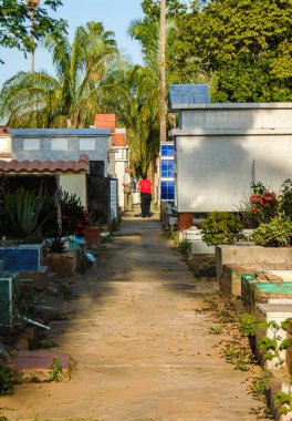 Two people standing at the end of a path in the Central Cemetery of Neiva - Huila - Colombia clipart