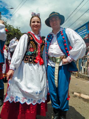 Neiva, Huila, Colombia - 30 June 2024 - Couple of European dancers in traditional dress smiling while looking at the camera clipart
