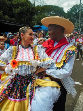 Neiva, Huila, Colombia - June 30, 2024 - Latin children dancing in traditional costumes in a parade at the San Juan and San Pedro Festival clipart