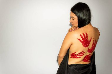 Young latina woman with long black hair with handprints and blood wound on her back with white background. Self love concept clipart