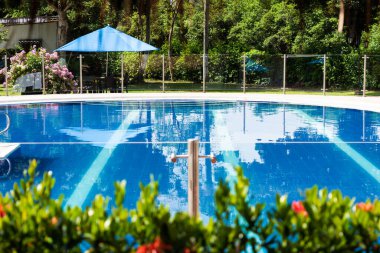 Blue pool for a perfect rest in a country hotel in Tocaima - Cundinamarca - Colombia. Travel and tourism concept clipart