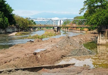 Mining on the Las Ceibas River during the day in Neiva - Huila - Colombia. Industry, mining and environment concept clipart