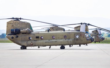 Graz, Austria - September 24, 2023: Boeing Vertol CH-47 Chinook military transport helicopter of US Army parked at the ramp clipart