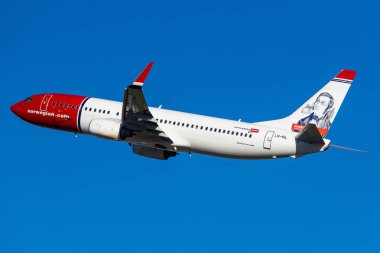 Salzburg, Austria - January 27, 2024: Norwegian Airlines, low cost airline from Norway, in the air with blue sky background clipart