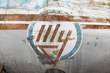 Riga, Latvia - June 1, 2023: Old company logo of russian aircraft manufacturer Tupolev on the fuselage of an retired aircraft, symbolic for the bad shape of the russian aviation industry clipart