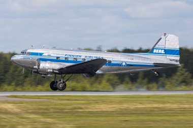 Helsinki, Finland - June 5, 2023: Beautiful Douglas DC-3 oldtimer aeroplane landing on the runway in Helsinki clipart