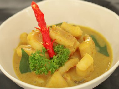 Gulai Cumi ya da kalamar hindistan cevizi sütüyle sarı baharat pişirmişler. Uzmanlık alanları Padang, Batı Sumatra Endonezya. Seçici odak.