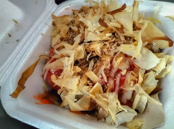 Takoyaki yemeğinin lezzeti. Beyaz köpük ambalajlı Takoyaki yemeği. Seçici odak.