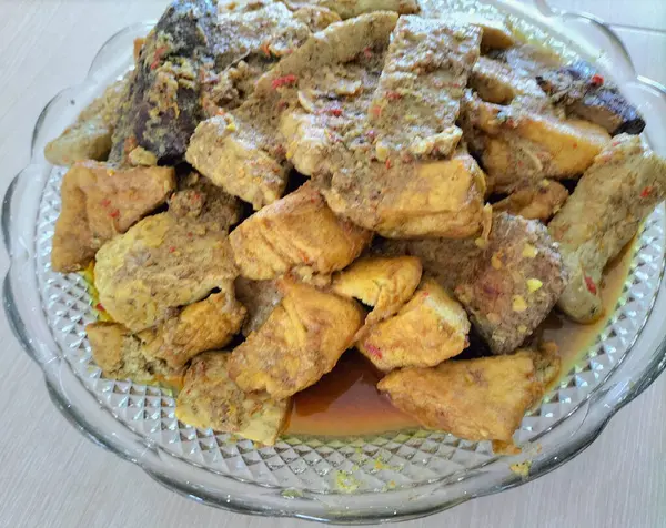 stock image Delicious Tuna fish curry with coconut milk, tofu and tempeh. Top view for Traditional Indonesian food.