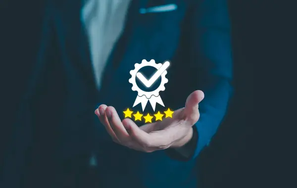 Quality assurance of product and service concept, Businessman showing the best quality assurance with golden five stars, Guarantee product, Certificate and standardization, Premium service assurance.