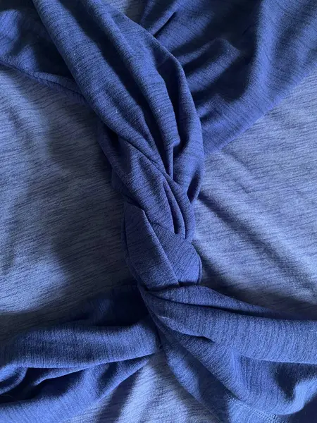 Closeup of blue shirt with sleeves twisted together