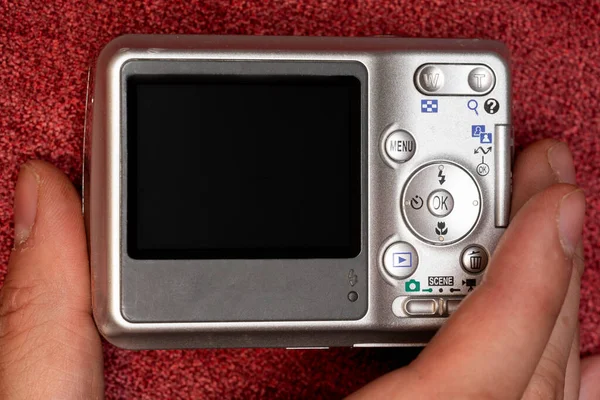 hand holding a vintage camera with copy space in camera screen