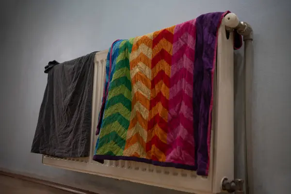 towel and t-shirt drying on radiator, energy saving, residual heat