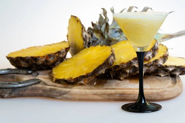 pineapple cocktail with slices of pineapple on the background