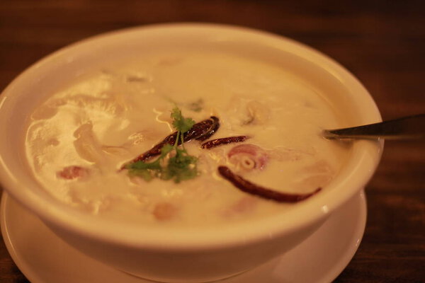 thai style soup with chicken, egg, milk and red chili sauce
