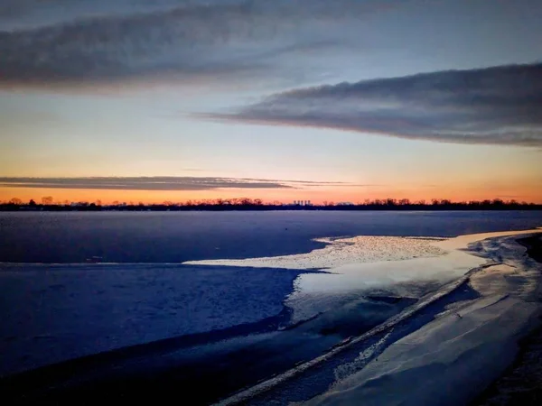 winter sunset in the lake. frozen lake