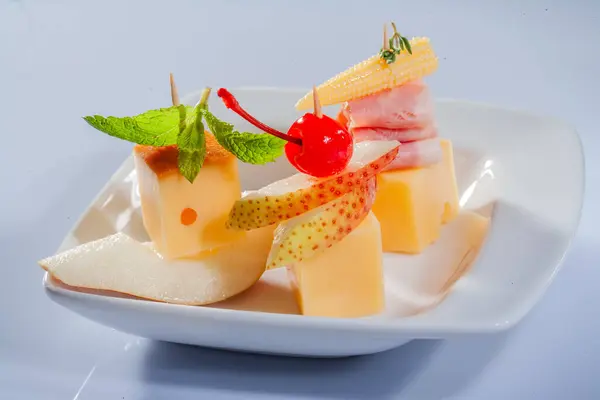 stock image Cheese and various cheese compositions with fruit. Hard cheese with different textures and colors. A variety of different types of hard cheese. Small pieces of cheese with fruit.