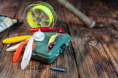 Soft silicone lures for fishing. Multi-colored lures for catching fish. Fishing box for fishing. Fishing composition. Lures on the table.