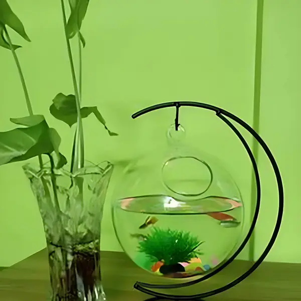 A fish bowl with fish in it and a plant in a vase.