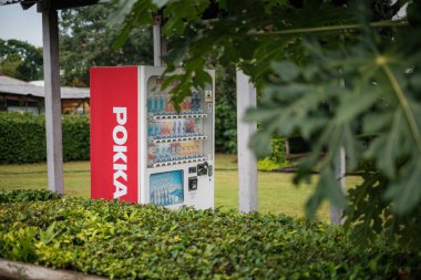 Singapore - July 9 2023: Pokka Vending Machine Behind Vegatation