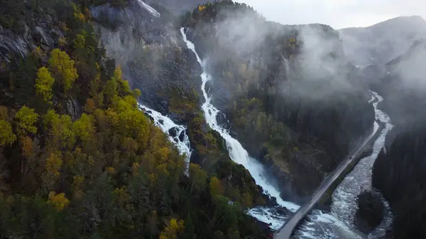 Güçlü çifte şelale Lotefossen. Yaz Temmuz yağmurlu bir gün. Şelale erime ve yağmur suyuyla beslenir. Havada bir su tozu bulutu asılı duruyor. Norveç 'e git. Odda Komünü