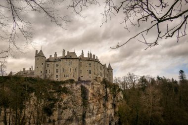 landscape photograph of the castle of Walzin situated on the heights of a hill romantic castle presenting a beautiful facade under a gray autumn sky. clipart