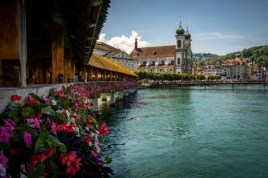 İsviçre, Lucerne 'deki Chapel Köprüsü veya Kapellbrucke. Dekoratif çiçekler ve Lucerne şehrinin manzarasıyla çekilmiş. Lucerne, İsviçre