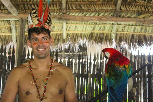 tourist visiting the tribes of amazon ecuador with a parrot
