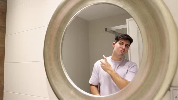4K视频剪辑白种人黑发男子放香水反映在浴室的镜子 — 图库视频影像
