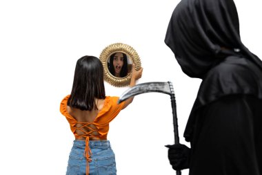 terrified young woman, viewed from behind and reflected in a mirror, is confronted by the grim reaper, dressed in a Halloween costume with dark cloak, as he menacingly holds a scythe white background clipart