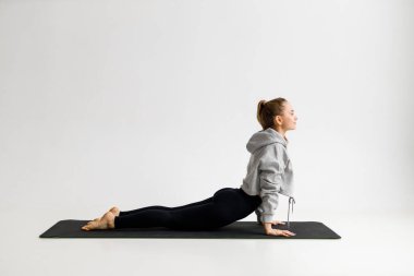 Young woman doing stretching before yoga, body care and weight loss.