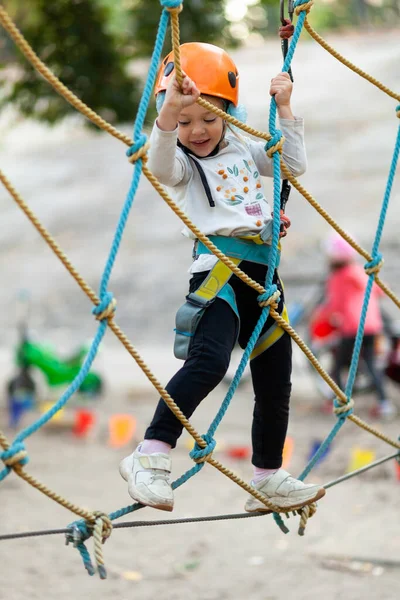 Маленькая Девочка Шлеме Лазает Канатам Парке Приключений Открытом Воздухе Экстремальный — стоковое фото