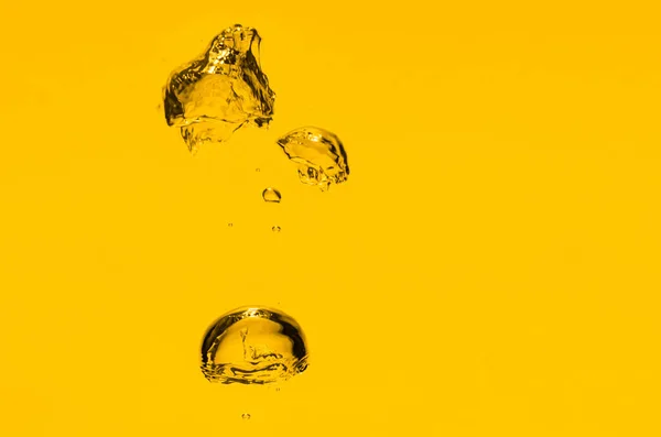 Gold (yellow) oil bubble background. Liquid drops in macro.