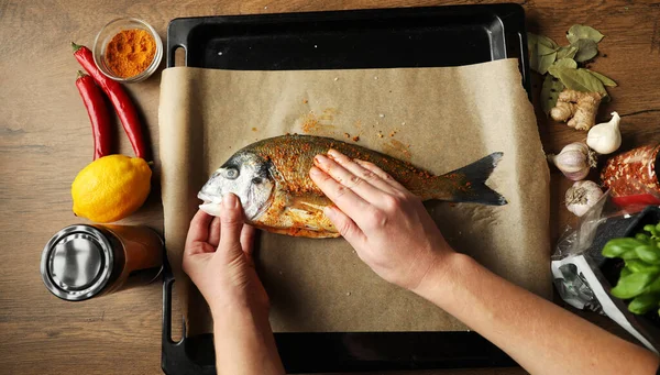 Marinating dorado fish in the kitchen, mediterranean diet.