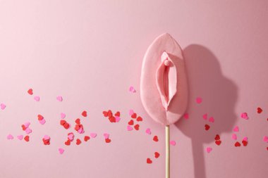 Sweet candy in the form of a female vagina, pleasure, oral sex concept.