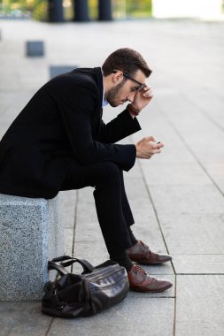Modern young man playing on phone, browsing mobile news. Gadget Dependence.