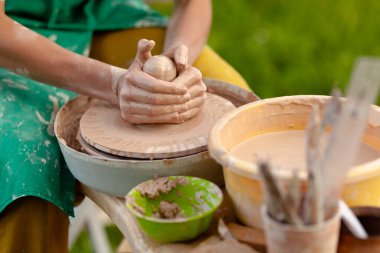 El işi çanak çömlek yapmak. Kadın elleri kilden seramik plaka kalıbı (esrar)).