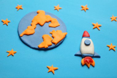 Rocket in space, star, planet earth. Plasticine art, cartoon.