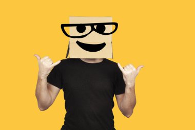 Funny man with box on his head and emoji having fun. Crazy rock and roll party and celebration.