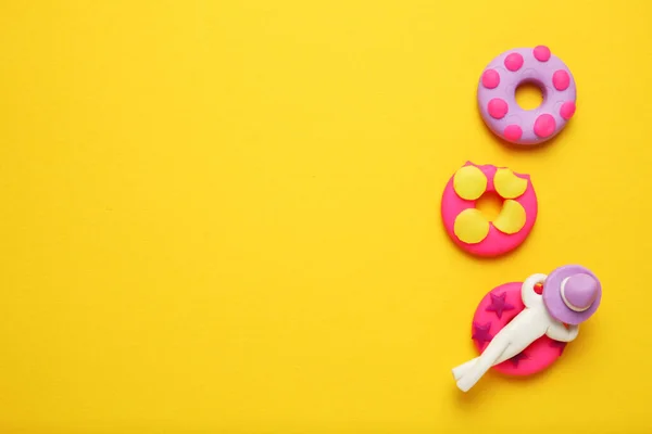 stock image Plasticine people relaxing on inflatable donut lilo in pool. Cartoon summer relaxing and holidays.