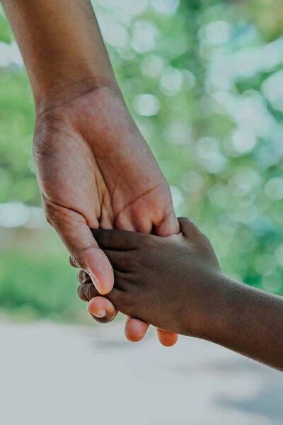 close - up of two hands holding the other child 's hand