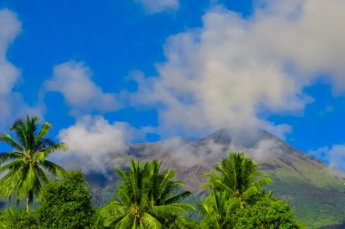 View of Mount Gamalama in North Maluku, Indonesia covered in clouds clipart