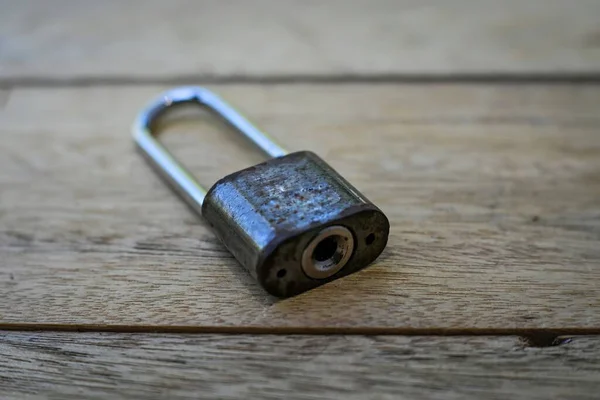 A padlock on a wooden plank background