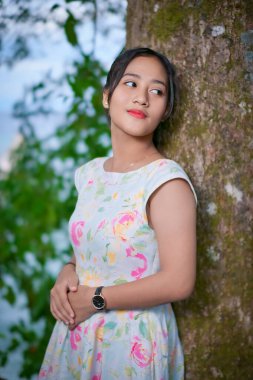 Parktaki Asyalı genç bir kızın portresi.