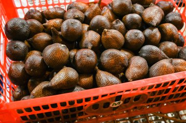Pile of snake fruit in a basket clipart