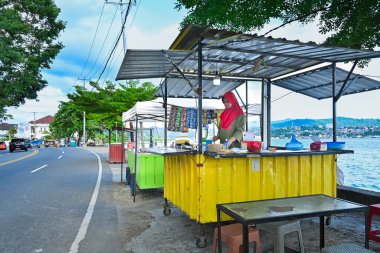 Ambon, Indonesia - April 7, 2024: The atmosphere of the month of Ramadan. Roadside food vendors clipart