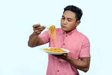An Asian man is eating noodles clipart